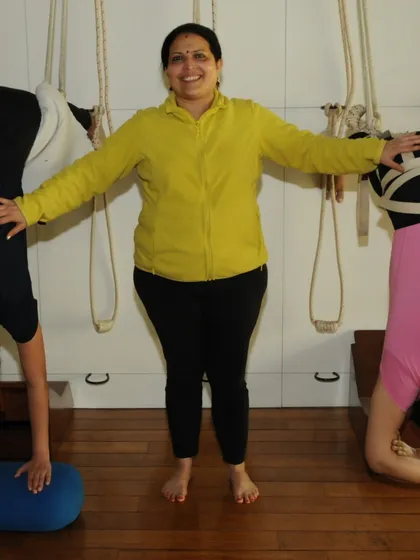 Here I am with students using the rope wall for supported inversions. This demonstrates how props are not just for individual practice but are integral to the group class experience, ensuring everyone can work safely at their own level.