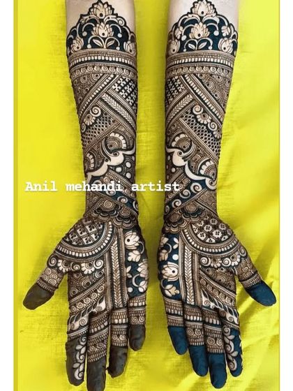Another stunning example of using negative space. The dark henna background makes the delicate white floral and elephant patterns stand out beautifully.