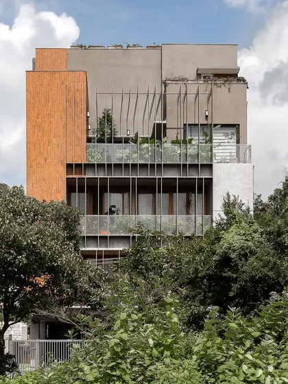 This is our 'Triode' multi-family residence, where we explored how to create privacy and community simultaneously. The custom louver system on the facade balances light and shade, connecting the apartments to the surrounding greenery while maintaining a sense of personal space for each family.