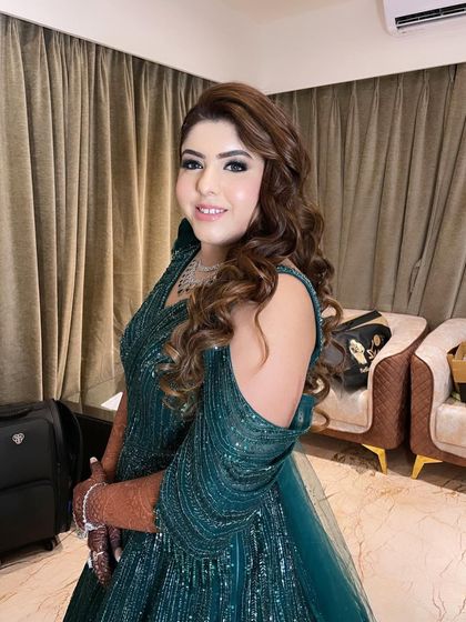 My beautiful bride Hani all glammed up for her Sangeet in an emerald green gown. We styled her with soft curls and a radiant makeup look.