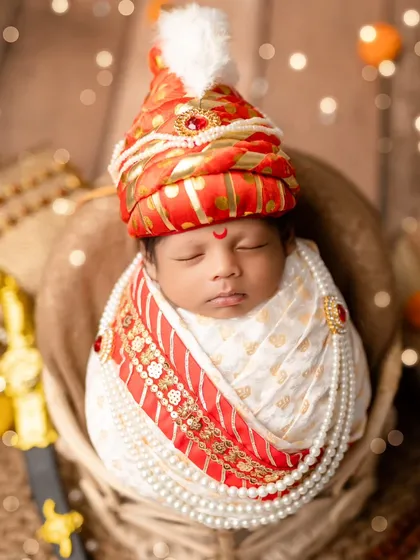 A portrait of a little 'Raje' in the style of Chhatrapati Shivaji Maharaj. We use a custom turban, pearl necklaces, and a miniature sword to create a look of tiny royalty.