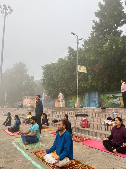 A wider view of our meditation session by the river, showing the peaceful coexistence of our practice with the life of the holy city.