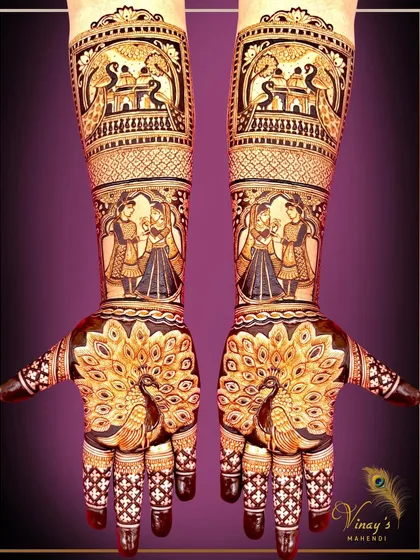 A design that combines grace and tradition. This full-hand bridal mehndi features stunning peacocks on the palms, with a detailed depiction of a wedding couple on the forearms, creating a narrative of love and celebration.