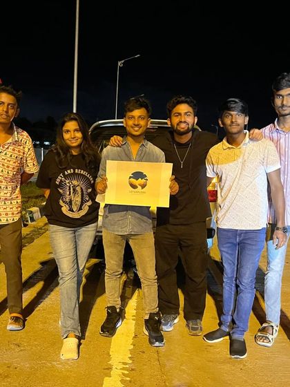 The group holding the 'Let's Explore' logo at the start of our Ooty trip. We are a community of explorers.