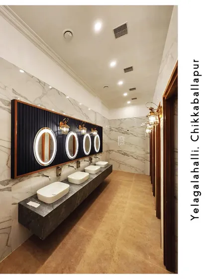 Another view of our premium restroom, focusing on the spacious vanity area with multiple sinks and well-lit mirrors, designed for your comfort and convenience.