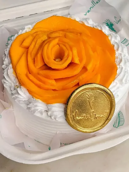 Our Mango Bento Cake, perfect for a personal indulgence. It features the same light cream and fresh mango as our larger cakes, topped with a beautiful mango rose.