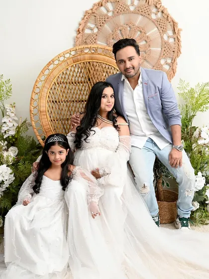 A perfect family portrait in our boho-chic setup. I love including older siblings and coordinating outfits, like this mother-daughter duo in matching white gowns, to create sweet, connected memories.