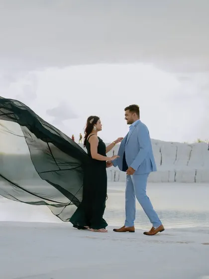 A dynamic shot where the wind and the bride's gown do all the talking. The movement creates a sense of freedom and joy, perfect for a pre-wedding photo.