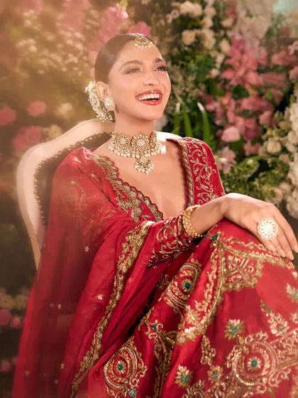 The pure joy of a bride on her special day. Her radiant smile is the centerpiece of this look, complemented by our soft bronze makeup and a sleek bun.
