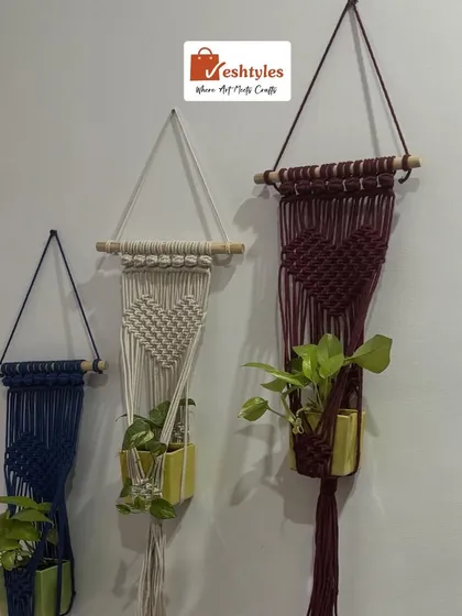 For all the plant lovers, here is a beautiful set of three wall plant hangers. I've made them in navy, off-white, and maroon, each with a unique heart-shaped knot pattern. They are perfect for creating a lovely green corner in your home or balcony.