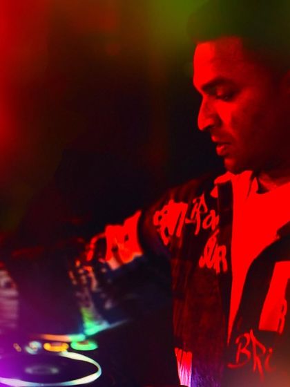 A colorful, artistic shot from behind the decks. The blend of red and green lights created a unique atmosphere for this particular night.