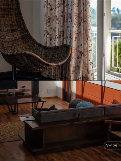 The interior features a hanging wicker swing chair, providing a perfect reading spot by the window. The living area is furnished with a comfortable sofa and wooden coffee table, creating a relaxed, modern farmhouse feel.