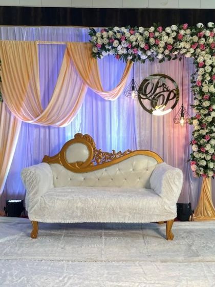 Another angle of the elegant engagement stage, showing the custom 'OP' monogram and the beautiful floral work.