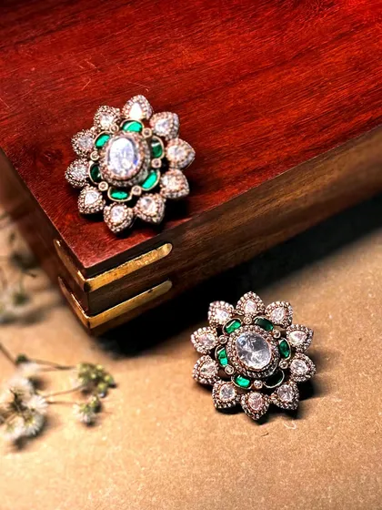 Festivities start with the tiniest sparkle. These beautiful floral studs are crafted with a central polki diamond surrounded by emerald green enamel.