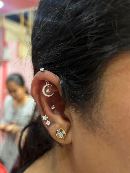 Another look at our popular celestial hanging, featuring a crescent moon and a dangling star, paired with a simple star stud.