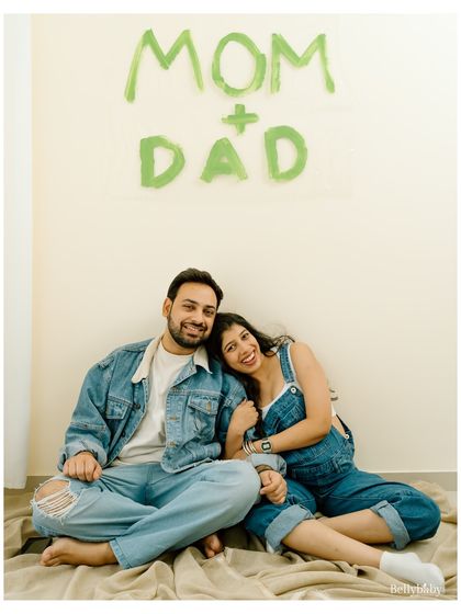 A beautiful, happy portrait of the parents-to-be. The hand-painted sign in the background makes it a perfect baby announcement photo.