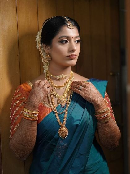 This bride's look is a testament to classic South Indian beauty. The combination of the silk saree, gold jewelry, and my signature subtle makeup creates a truly timeless appeal.