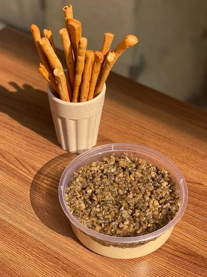This is my classic hummus, elevated with a topping of truffle oil and mushrooms. It's a gourmet dip that's perfect for any occasion.