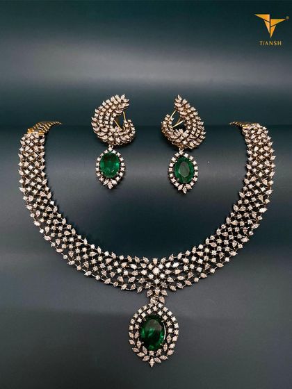 This exquisite Diamond and Emerald Set is like wrapping yourself in love and heritage. The leaf-like pattern of the diamonds and the deep green of the emeralds create a truly captivating look.