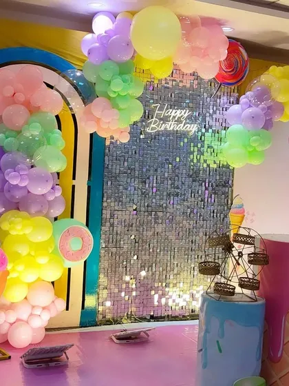 A different angle of our sweet Candyland theme decoration. This view highlights the giant ice cream cone prop, pastel balloon clouds, and the shimmering backdrop that adds a touch of magic to the setup.