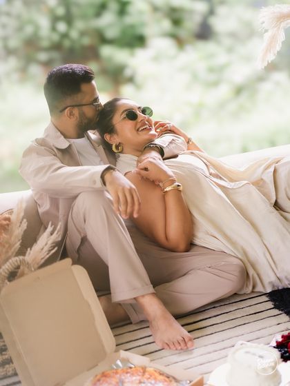 A relaxed and happy moment during an indoor picnic. The natural light and comfortable setting allow for genuine smiles and affectionate interactions, which are the heart of our candid photography style.