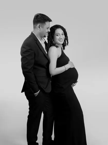 A classic black and white couple's portrait. The elegant formal wear and simple background create a sophisticated and timeless look.
