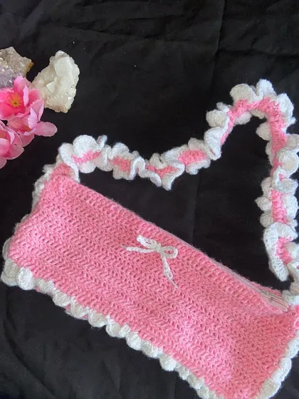 My pink and white ruffle bag! This is the ultimate coquette accessory. It has a ruffled strap, a ruffled edge, and a tiny bow. It also comes with a zipper to keep your things secure.
