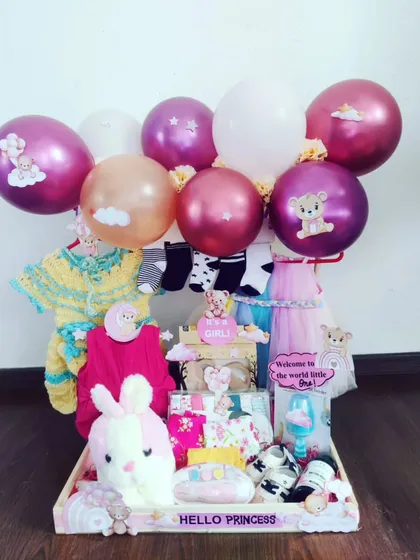 Hello, Princess! This hamper is all about celebrating a baby girl with soft pinks and purples. I've included cozy knitwear, a plush bunny, and festive balloons to create a beautiful and practical gift for a baby shower or to welcome the newborn.