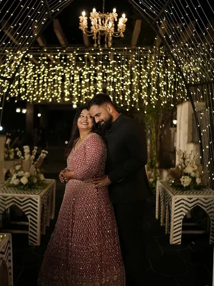 A romantic portrait of a couple, framed by an enchanting tunnel of fairy lights. This kind of lighting design not only looks spectacular but also creates beautiful, intimate photo opportunities.