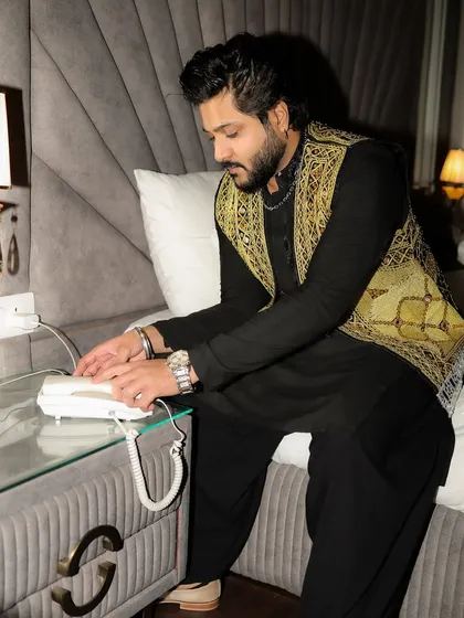 A candid moment before the show, making a call. The life of an artist is always on the go.