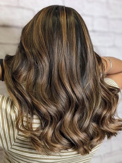 This is the beautiful result of a Tobacco Brown and Irish Coffee inspired hair color. The after shot shows a cozy masterpiece of earthy tones and creamy warmth, full of dimension and shine.