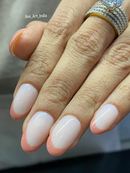 A close-up of the peach French tips, highlighting the flawless application and glossy finish.