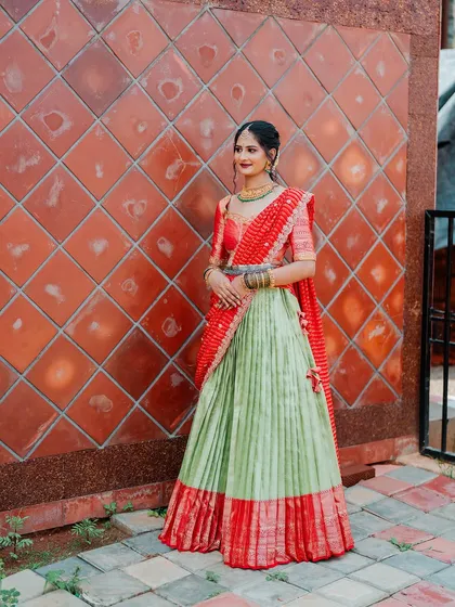 My beautiful client Chethana looks stunning in this custom Kanchi Pattu tissue lehenga. The sea-green and red combination is a classic, and I designed it as a Langa Voni for a traditional yet fresh look for her special day.
