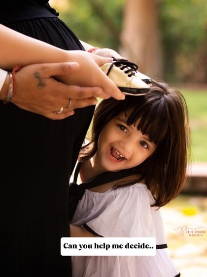 A playful peek-a-boo with the baby bump. Including older siblings in the photoshoot is a wonderful way to make them feel involved and excited about their new role.