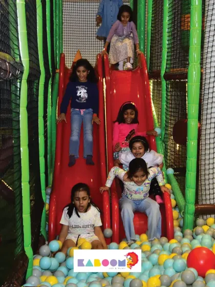 A train of friends sliding into the ball pit! The more, the merrier on our multi-lane slides.
