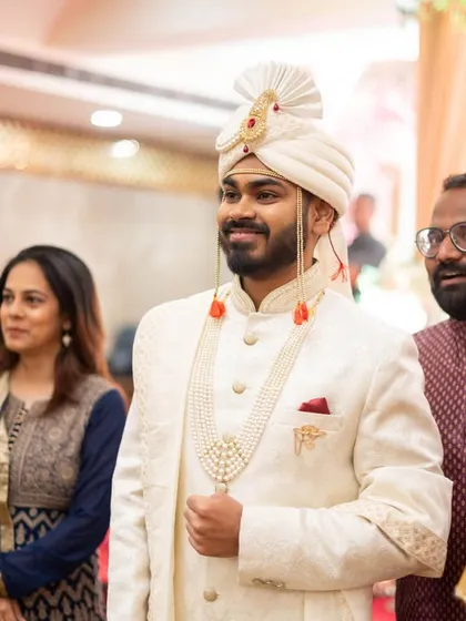 The groom's proud and happy expression as he waits for his bride.