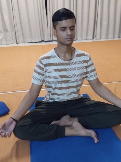 A young participant sits with serene focus, demonstrating that the practice is accessible to all who are willing.