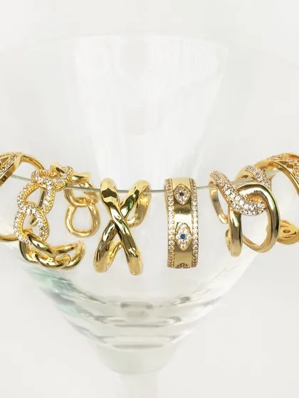 Make a statement with my newly launched gold rings. This image shows a variety of styles, from the classic evil eye band to the chunky bow-shaped stack.