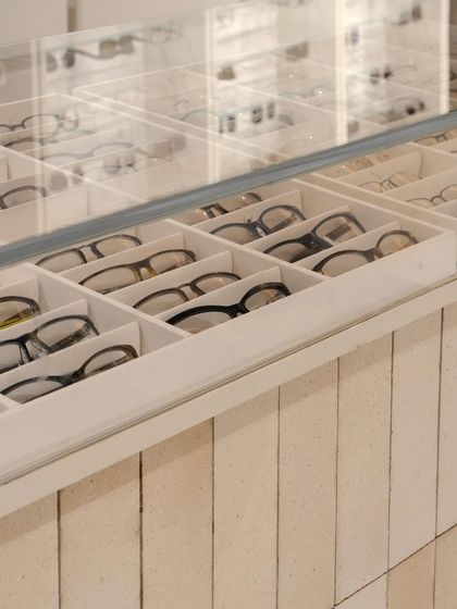 Custom-designed display drawers with individual compartments provide organized, accessible storage for eyewear, showcasing our attention to the functional needs of a retail environment.
