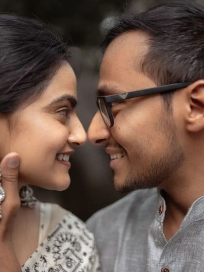 A sweet, intimate nose-to-nose pose. This close-up shot emphasizes the couple's connection and the beautiful details, like the bride's traditional earrings.