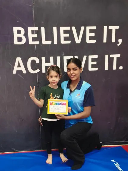 Another one of our June certifications. This young gymnast flashes a peace sign, happy with her new achievement.