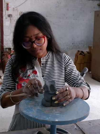 A student sculpting a small Ganesha idol. It's wonderful to see personal and cultural expression come to life through clay.