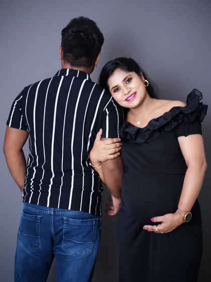 A sweet and intimate pose from a studio maternity shoot, showing the connection between the couple as they await their little one.
