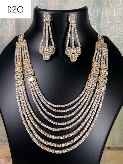 This is a stunning multi-layered American diamond necklace in a silver and gold dual-tone finish. It's a grand piece to rent for a wedding or reception, giving you a full and luxurious look.