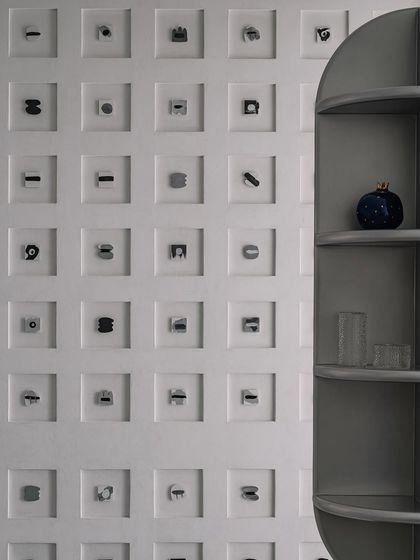 A key feature of the living room is the 'Decode 260' Morse code wall, which subtly tells the couple's journey. This, along with the sculptural totem shelving unit, adds to the home's character as a 'house of curiosity'.