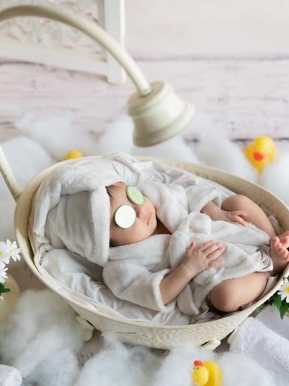 Time for a bubble bath. This adorable spa-themed shot features a baby with cucumber slices, ready for some pampering.