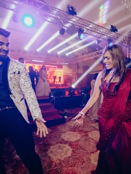 Dancing with a guest at a Sangeet. I make it a point to interact with everyone, ensuring no one feels left out of the fun.
