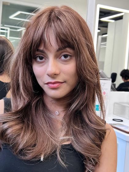 A beautiful color and cut that is perfect for framing the face. The subtle highlights and soft layers create a look that is both modern and timeless.