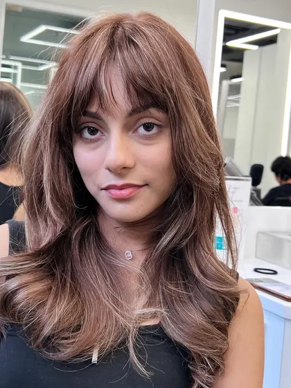 A beautiful color and cut that is perfect for framing the face. The subtle highlights and soft layers create a look that is both modern and timeless.