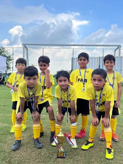 The team with their medals and trophy after the Pride Cup. These moments celebrate their hard work and dedication.